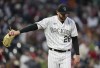 Colorado Rockies starting pitcher Austin Gomber catches a new ball after giving up a solo home run to Philadelphia Phillies' Alec Bohm during the seventh inning of a baseball game Friday, May 12, 2023, in Denver. (AP Photo/David Zalubowski)