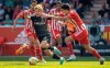 Berlin's Rani Khedira, right, and Freiburg's Ritsu Doan, left, challenge for the ball during the German Bundesliga soccer match between 1. FC Union Berlin and SC Freiburg in Berlin, Germany, Saturday, May 13, 2023. (Andreas Gora/dpa via AP)