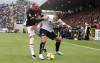 Spezia's Salvatore Esposito is challenged by AC Milan's Theo Hernandez, left, during the Serie A soccer match between Spezia and AC Milan, at the Alberto Picco stadium in La Spezia, Italy, Saturday, May 13, 2023. (Tano Pecoraro/LaPresse via AP)