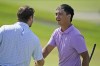 Zecheng Dou, of China, shakes hands after finishing the 18th hole during the third round of the Byron Nelson golf tournament in McKinney, Texas, Saturday, May 13, 2023. (AP Photo/LM Otero)