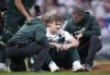 Trainers tend to Colorado Rockies starting pitcher Ryan Feltner after he was hit by a batted ball from Philadelphia Phillies' Nick Castellanos, who singled during the second inning of a baseball game Saturday, May 13, 2023, in Denver. (AP Photo/David Zalubowski)