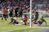 Brentford's Yoane Wissa, center, is tackled during the English Premier League soccer match between Brentford and West Ham at the Gtech Community Stadium, London, Sunday, May 14, 2023. (Steven Paston/PA via AP)