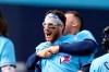 Toronto Blue Jays catcher Danny Jansen (9) is hugged by teammate Matt Chapman after hitting a game-winning two-run single against the Atlanta Braves during ninth inning interleague baseball action in Toronto, on Sunday, May 14, 2023. THE CANADIAN PRESS/Frank Gunn