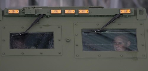 A soldier is seen through a window of a vehicle carrying one of U.S.-made HIMARS mobile rocket, at an air base in Warsaw, Poland, on Monday, 15 May 2023. Poland has received its first shipment of U.S.-made HIMARS rocket launchers, part of an upgrade of its defenses amid security concerns due to the war in neighboring Ukraine. (AP Photo/Czarek Sokolowski)
