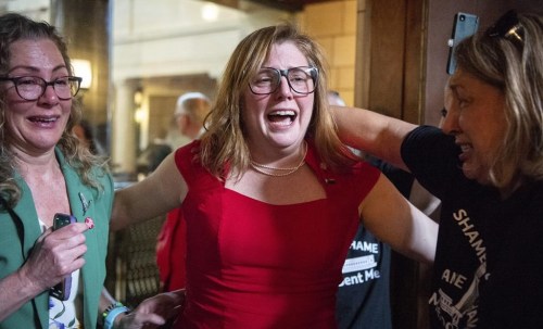 FILE - State Sen. Machaela Cavanaugh, center, hugs supporters, April 27, 2023, at the Nebraska State Capital in Lincoln, Neb. Conservative Nebraska lawmakers are taking what could be an all-or-nothing bet by proposing to merge two of the session's most contentious proposals — one to restrict abortion access and another that would ban gender-affirming care for transgender minors. The strategy sets up a vote on Tuesday, May 16, 2023 that could give conservatives a win on both abortion and trans health bans this year — or could see them lose both. (Larry Robinson/Lincoln Journal Star via AP, file)