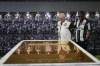 Fans visit the tomb of the late Brazilian soccer great Pele which became open to the public for the first time at the mausoleum of Necropole Ecumenica Memorial Cemetery in Santos, Brazil, Monday, May 15, 2023. (AP Photo/Andre Penner)