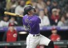 Colorado Rockies' Brenton Doyle follows the flight of his solo home run off Cincinnati Reds relief pitcher Buck Farmer in the eighth inning of a baseball game Monday, May 15, 2023, in Denver. (AP Photo/David Zalubowski)