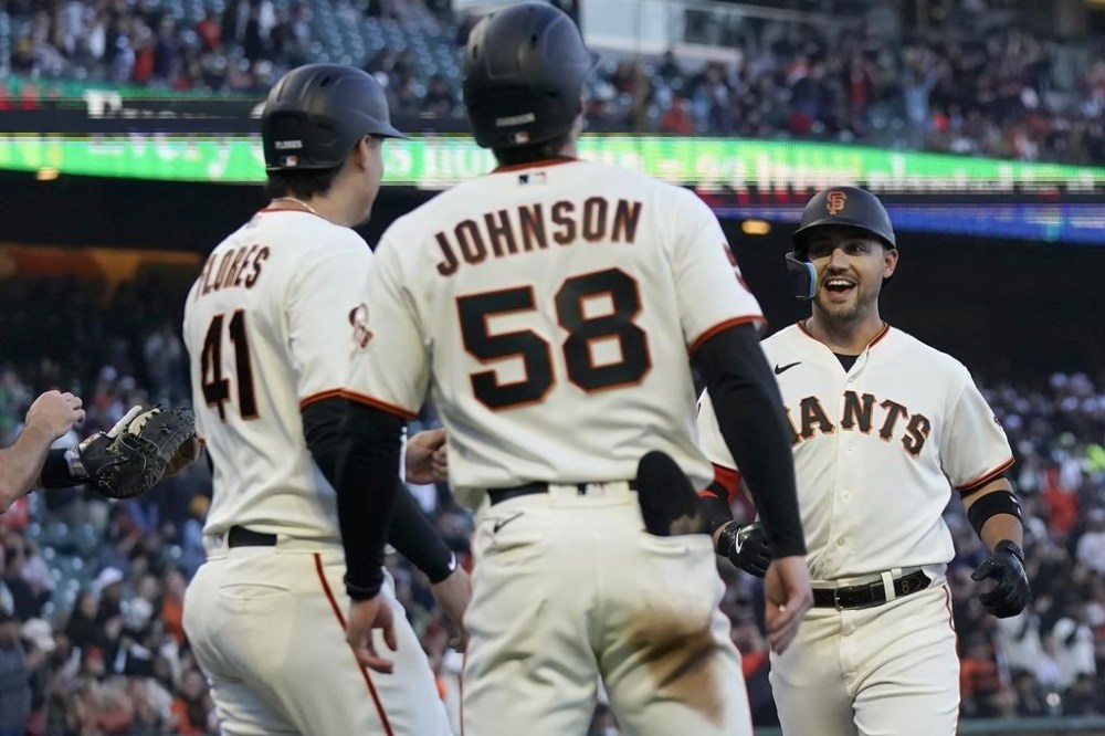 San Francisco Giants' Michael Conforto, right, celebrates after hitting a three-run home run that scored Wilmer Flores (41) and Bryce Johnson (58) during the second inning of a baseball game against the Philadelphia Phillies in San Francisco, Monday, May 15, 2023. (AP Photo/Jeff Chiu)