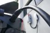 An electric vehicle is charged in Ottawa on Wednesday, July 13, 2022. Canada and the U.S. are teaming up to build a corridor of charging stations between Quebec City and Michigan to encourage motorists in both countries to buy more electric vehicles.THE CANADIAN PRESS/Sean Kilpatrick