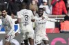 Lille's Jonathan David, right, celebrates with his teammates after scoring his side's second goal during the French League One soccer match between Paris Saint-Germain and Lille at the Parc des Princes stadium, in Paris, France, Sunday, Feb. 19, 2023. (AP Photo/Christophe Ena)