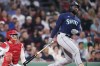 Seattle Mariners' Taylor Trammell watches the flight of his two-run home run off Boston Red Sox starting pitcher Nick Pivetta during the fourth inning of a baseball game at Fenway Park, Tuesday, May 16, 2023, in Boston. (AP Photo/Charles Krupa)