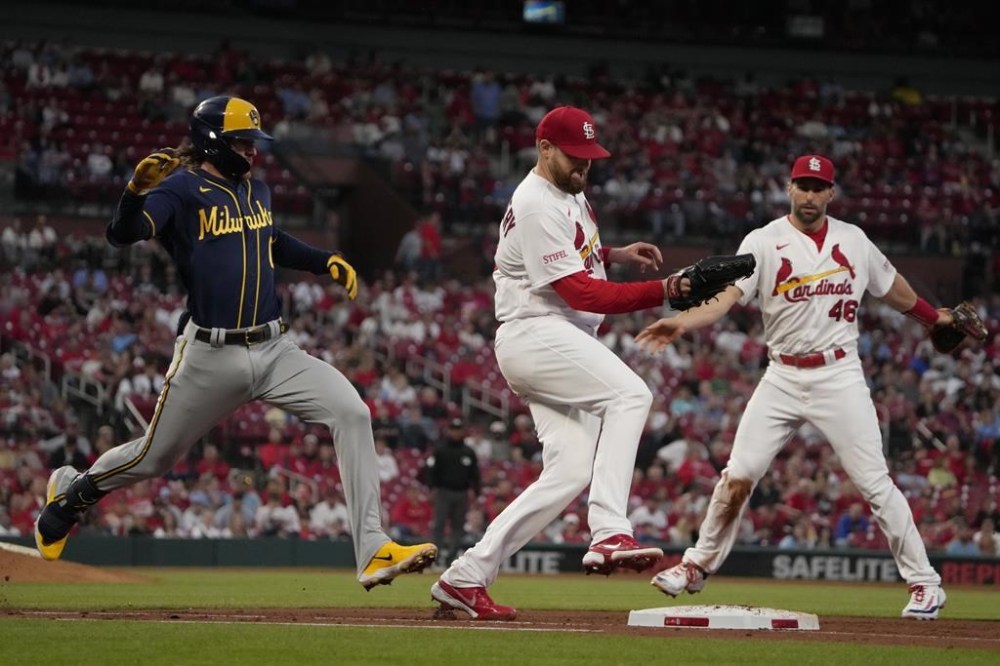 Milwaukee Brewers' Brice Turang, left, is forced out at first by St. Louis Cardinals starting pitcher Jordan Montgomery as Cardinals first baseman Paul Goldschmidt, right, watches during the fifth inning of a baseball game Tuesday, May 16, 2023, in St. Louis. (AP Photo/Jeff Roberson)