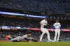 Minnesota Twins designated hitter Byron Buxton, left, reaches first ahead of a throw to Los Angeles Dodgers starting pitcher Clayton Kershaw, center, during the third inning of a baseball game in Los Angeles, Tuesday, May 16, 2023. (AP Photo/Ashley Landis)
