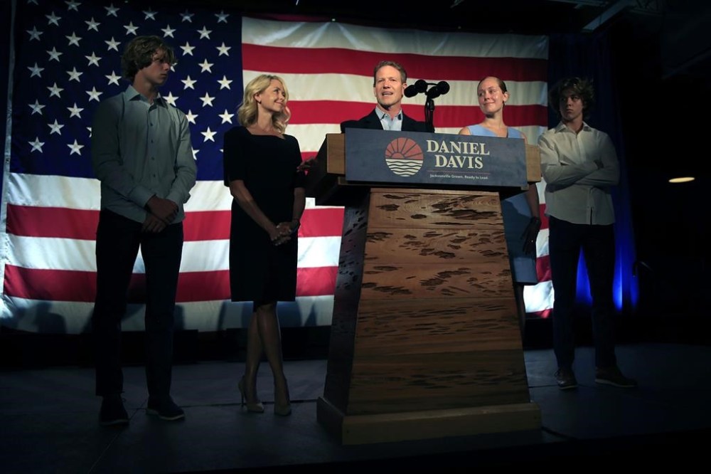 Daniel Davis, center, Republican candidate for mayor of Jacksonville, Fla., delivers his concession speech as family, son, Christian, 18, wife, Rebekah, daughter, Caroline, 20, and son, Gabe, 15, look on during an election night watch party Tuesday, May 16, 2023, at The Glass Factory in Jacksonville, Fla. Democrat Donna Deegan defeated Davis. (Corey Perrine/The Florida Times-Union via AP)