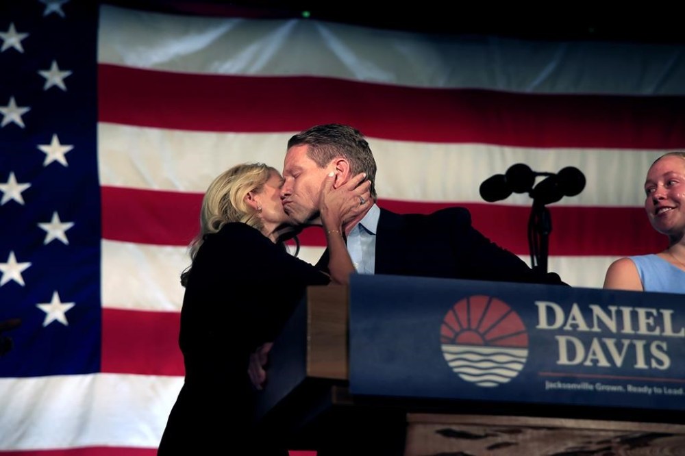 Daniel Davis, Republican candidate for mayor of Jacksonville, Fla., kisses wife, Rebekah, as daughter, Caroline, 20, looks on after delivering his concession speech during an election night watch party Tuesday, May 16, 2023, at The Glass Factory in Jacksonville, Fla. Democrat Donna Deegan defeated Davis. (Corey Perrine/The Florida Times-Union via AP)