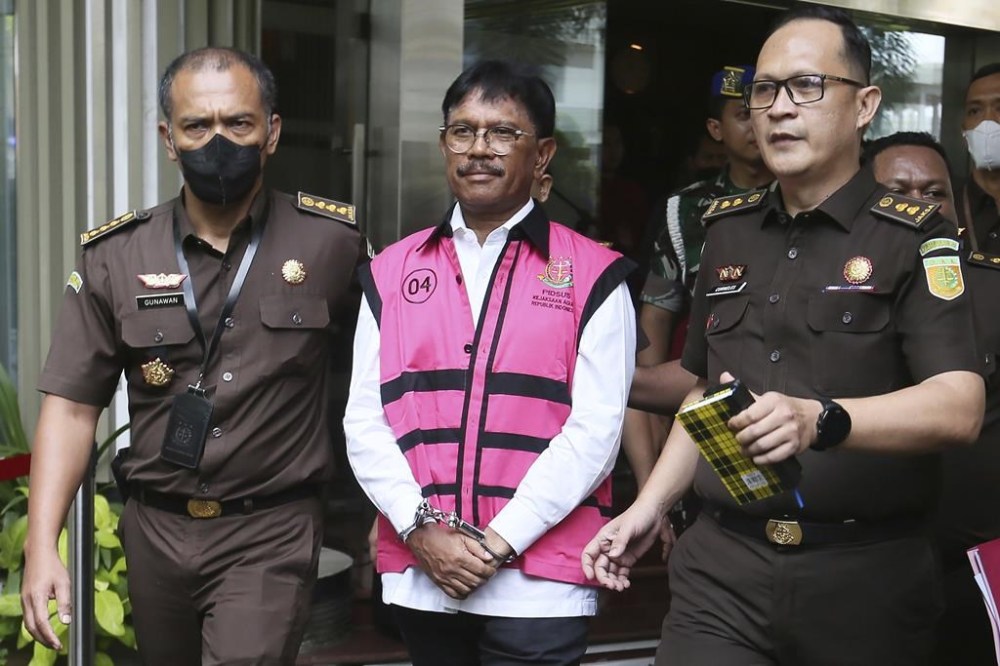 Indonesian Communication and Information Minister Johnny G. Plate, center, is escorted by prosecutors following his arrest on accusation of corruption, at the Attorney General's Office in Jakarta, Indonesia, Wednesday, May 17, 2023. Indonesian authorities on Wednesday arrested Plate as part of an investigation into a corruption scandal linked to the construction of mobile phone communication towers in remote regions in the country. (AP Photo)