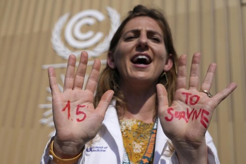 FILE - A demonstrator shows her hands reading 