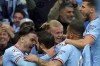 Manchester City's Bernardo Silva, second left, celebrates scoring with teammates during the Champions League semi-final second leg match between Manchester City and Real Madrid, at Etihad Stadium, in Manchester, England, Wednesday May 17, 2023. (Nick Potts/PA via AP)