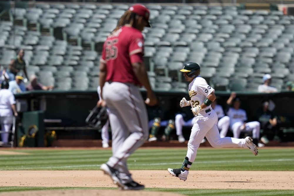 Oakland Athletics' Ramón Laureano, right, runs the bases after hitting a three-run home run against Arizona Diamondbacks starting pitcher Luis Frías, foreground, during the seventh inning of a baseball game in Oakland, Calif., Wednesday, May 17, 2023. (AP Photo/Godofredo A. Vásquez)