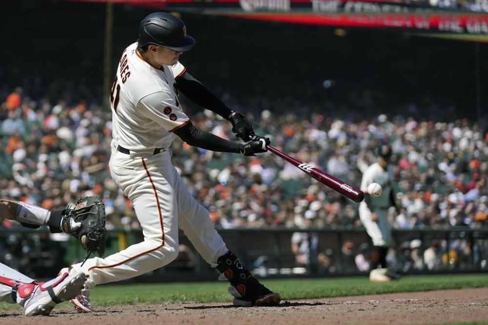 San Francisco Giants' Wilmer Flores hits a two-run single during the eighth inning of a baseball game against the Philadelphia Phillies in San Francisco, Wednesday, May 17, 2023. (AP Photo/Jeff Chiu)