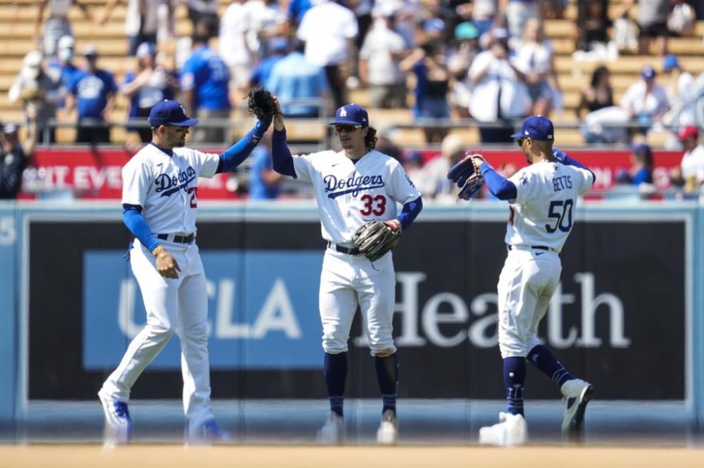 Los Angeles Dodgers left fielder Trayce Thompson (25), center fielder James Outman (33), and right fielder Mookie Betts (50) celebrate after a 7-3 win over the Minnesota Twins in a baseball game in Los Angeles, Wednesday, May 17, 2023. (AP Photo/Ashley Landis)