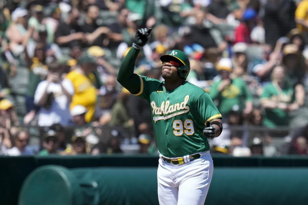 Oakland Athletics' Jesús Aguilar celebrates after hitting a two-run home run against the Cincinnati Reds during the first inning of a baseball game in Oakland, Calif., Sunday, April 30, 2023. (AP Photo/Godofredo A. Vásquez)