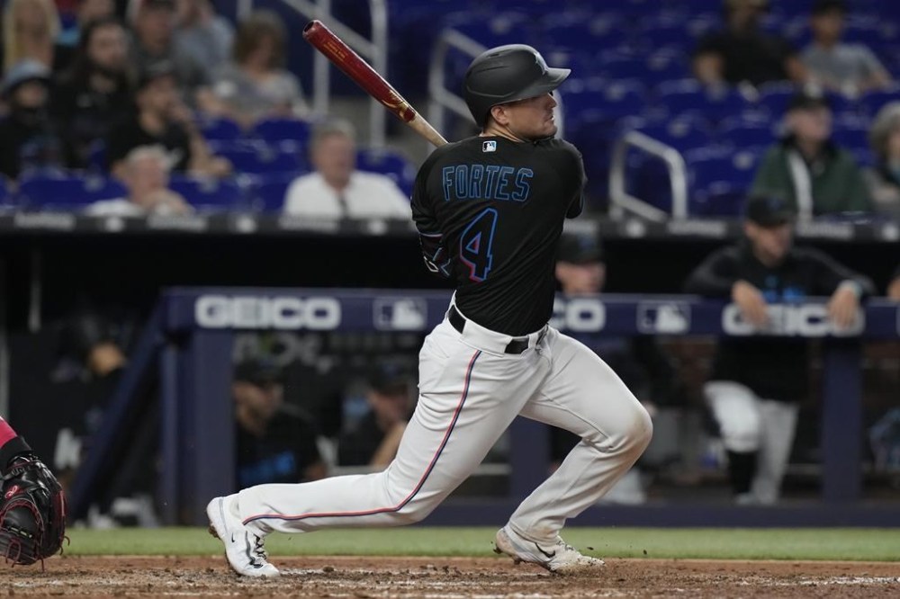 Miami Marlins catcher Nick Fortes (4) singles to right field during the eighth inning of a baseball game against the Washington Nationals, Thursday, May 18, 2023, in Miami. (AP Photo/Marta Lavandier)