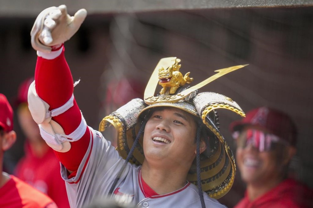 Los Angeles Angels designated hitter Shohei Ohtani celebrates in the dugout after hitting a home run against the Baltimore Orioles during the first inning of a baseball game at Oriole Park at Camden Yards, Thursday, May 18, 2023, in Baltimore. (AP Photo/Jess Rapfogel)