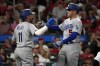 Los Angeles Dodgers' Freddie Freeman (5) gets a hug from teammate Miguel Rojas (11) after hitting a grand slam during the sixth inning of a baseball game against the St. Louis Cardinals Thursday, May 18, 2023, in St. Louis. (AP Photo/Jeff Roberson)