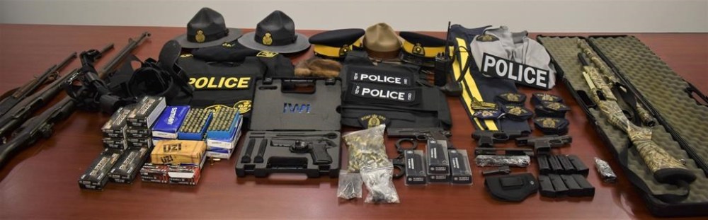 Police in Cape Breton say a local man is facing 21 charges after a search of a residence turned up seven firearms, more than 1,000 rounds of ammunition and several articles of police clothing and equipment, as shown in this handout image provided by the Cape Breton Regional Police Service, believed to from the RCMP and Ontario Provincial Police. THE CANADIAN PRESS/HO-Cape Breton Regional Police Service
**MANDATORY CREDIT **