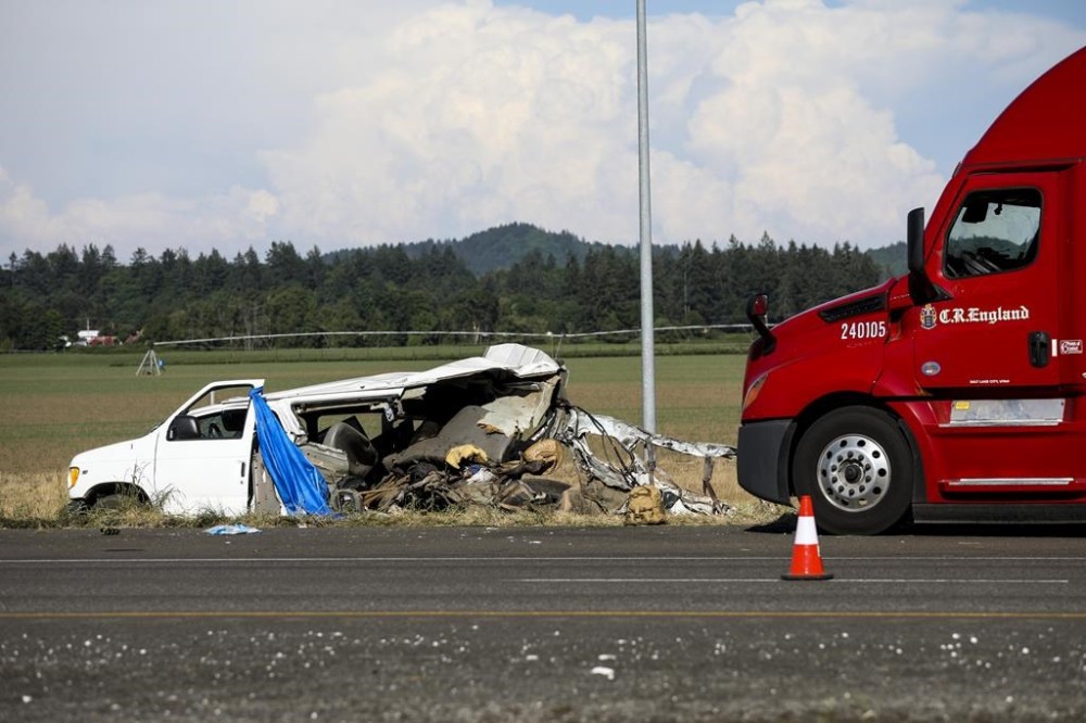 A damaged vehicle sits on the side of the road on Interstate 5, Northbound on Thursday, May 18, 2023, in Marion County, Ore. Two semi-trucks and a passenger van were involved in a deadly crash, which occurred near the city of Albany in an agricultural area of western Oregon, state police said on Thursday. (Abigail Dollins/Statesman Journal via AP)