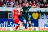 Freiburg's Roland Sallai, left, and Wolfsburg's Jakub Kaminski battle for the ball during the Bundesliga soccer match between SC Freiburg and VfL Wolfsburg at Europa-Park Stadion, Freiburg, Germany, Friday May 19, 2023. (Tom Weller/dpa via AP)