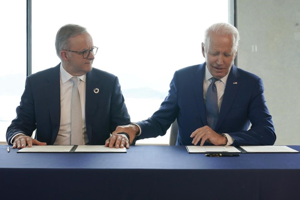 President Joe Biden, right, gestures to Australia's Prime Minister Anthony Albanese following a document signing ceremony on the sidelines of the G7 Summit in Hiroshima, Japan, Saturday, May 20, 2023. (AP Photo/Susan Walsh)