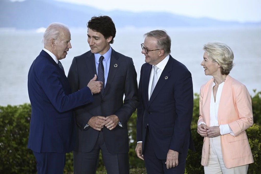 U.S. President Joe Biden, left, speaks with Canada's Prime Minister Justin Trudeau, center, Australia's Prime Minister Anthony Albanese, second right, and European Commission President Ursula von der Leyen during a a family photo session of leaders of the G7 and invited countries during the G7 Leaders' Summit in Hiroshima, western Japan, Saturday, May 20, 2023. (Brendan Smialowski/Pool Photo via AP)