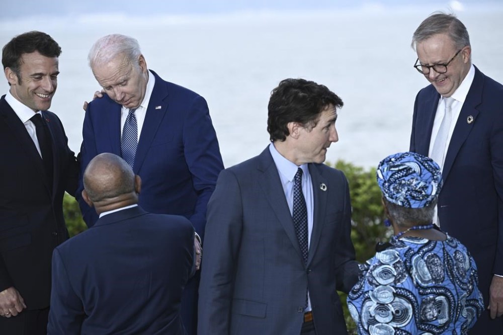 France's President Emmanuel Macron, left, speaks with U.S. President Joe Biden after a groupo photo of leaders of the G7 and invited countries during the G7 Leaders' Summit in Hiroshima, western Japan, Saturday, May 20, 2023. (Brendan Smialowski/Pool Photo via AP)