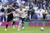Brentford's Ben Mee, left and Tottenham Hotspur's Dejan Kulusevski vie for the ball, during the English Premier League soccer match between Tottenham Hotspur and Brentfor, at the Tottenham Hotspur Stadium, London, Saturday May 20, 2023. (John Walton/PA via AP)