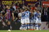 Real Sociedad players celebrate after scoring the opening goal during a Spanish La Liga soccer match between Barcelona and Real Sociedad at Camp Nou stadium in Barcelona, Spain, Saturday, May 20, 2023. (AP Photo/Joan Monfort)