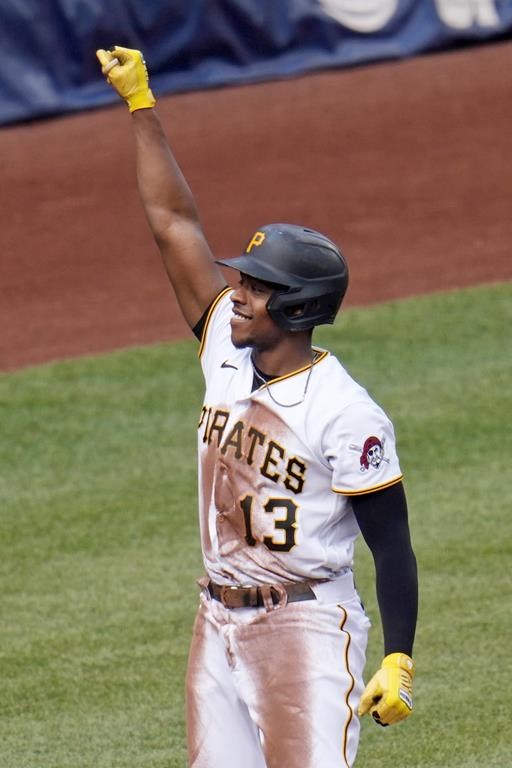 Pittsburgh Pirates' Ke'Bryan Hayes celebrates as he stands on third base after driving in three runs with a triple off Arizona Diamondbacks starting pitcher Brandon Pfaadt during the third inning of a baseball game in Pittsburgh, Saturday, May 20, 2023. (AP Photo/Gene J. Puskar)