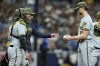 Milwaukee Brewers manager Craig Counsell, second from left, takes the ball from starting pitcher Eric Lauer as he is taken out of the game against the Tampa Bay Rays during the fourth inning of a baseball game Saturday, May 20, 2023, in St. Petersburg, Fla. Catching for Milwaukee is Victor Caratini. (AP Photo/Chris O'Meara)