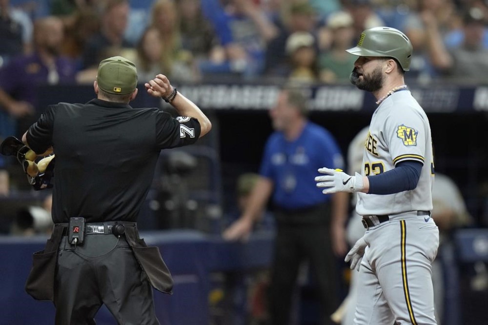 Home plate umpire Adam Hamari ejects Milwaukee Brewers' Jesse Winker (33) after he argued a clock violation during the eighth inning of a baseball game against the Tampa Bay Rays Saturday, May 20, 2023, in St. Petersburg, Fla. (AP Photo/Chris O'Meara)