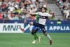 Vancouver Whitecaps' Brian White, front, and Seattle Sounders' Yeimar Gomez vie for the ball during the first half of an MLS soccer match in Vancouver, on Saturday, May 20, 2023. THE CANADIAN PRESS/Darryl Dyck