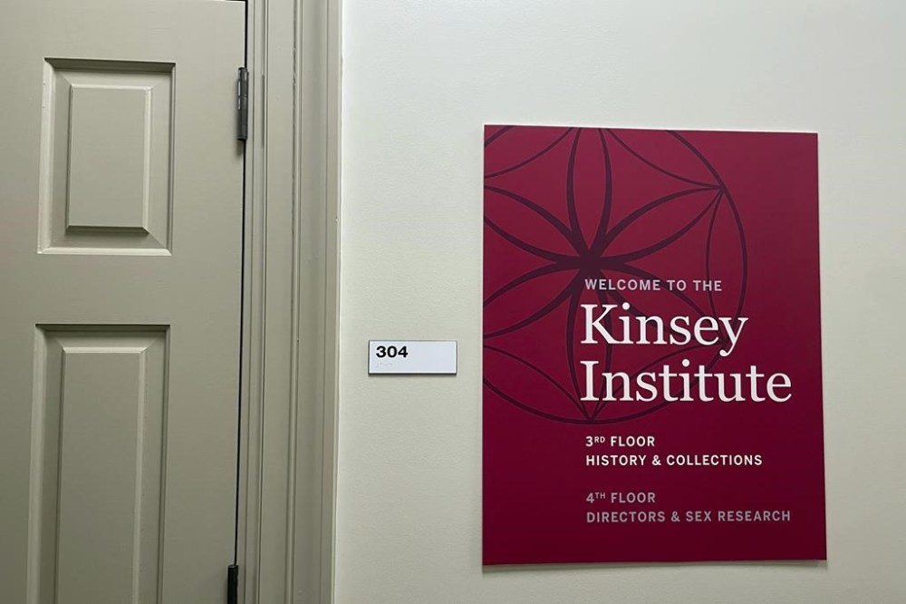 A sign for the Kinsey Institute, Indiana University's branch of sex research that the Indiana Legislature in February 2023 voted to prohibit from accessing state funding, hangs on the wall of the research building, Tuesday, May 16, 2023, in Bloomington, Ind. (AP Photo/Arleigh Rodgers)