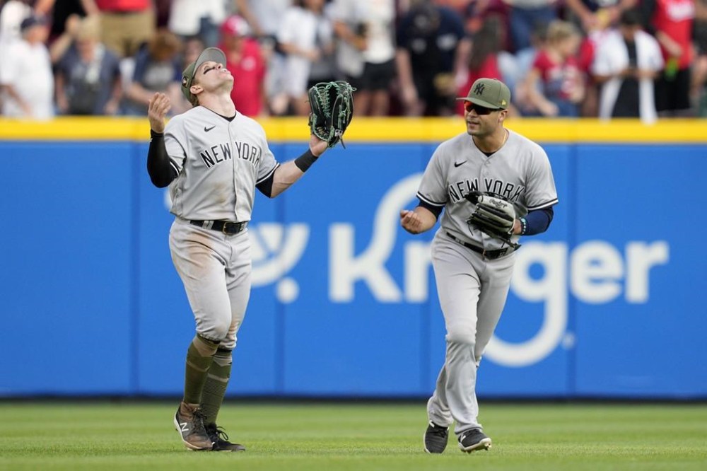New York Yankees' Harrison Bader, left and Isiah Kiner-Falefa celebrate following a baseball game against the Cincinnati Reds in Cincinnati, Saturday, May 20, 2023. (AP Photo/Jeff Dean)