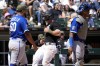 Chicago White Sox's Romy Gonzalez, center, scores on a sacrifice fly by Andrew Benintendi, center, as Kansas City Royals relief pitcher Max Castillo, left, and catcher Salvador Perez look to left field during the fifth inning of a baseball game in Chicago, Sunday, May 21, 2023. (AP Photo/Nam Y. Huh)