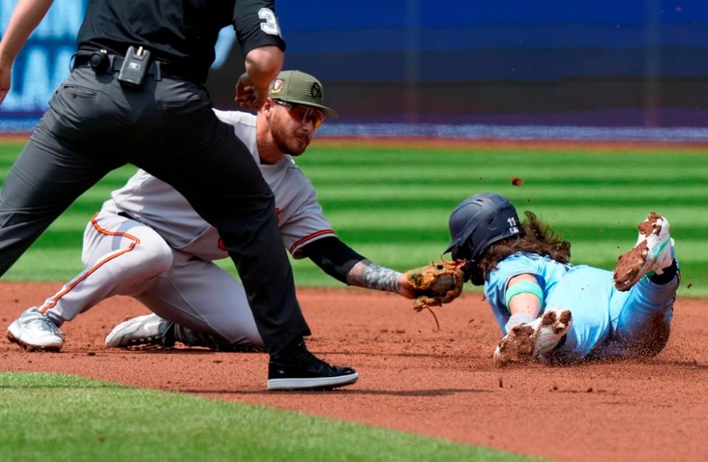 Baltimore Orioles shortstop Joey Ortiz (65) tags out Toronto Blue Jays Bo Bichette on a steal attempt of second base during first inning American League baseball action in Toronto on Sunday, May 21, 2023. THE CANADIAN PRESS/Frank Gunn