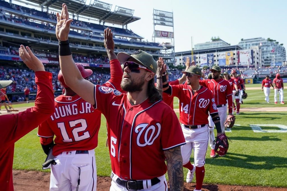 Washington Nationals second baseman Michael Chavis (6) and others, celebrate after a baseball game against the Detroit Tigers at Nationals Park, Sunday, May 21, 2023, in Washington. The Nationals won 6-4. (AP Photo/Alex Brandon)