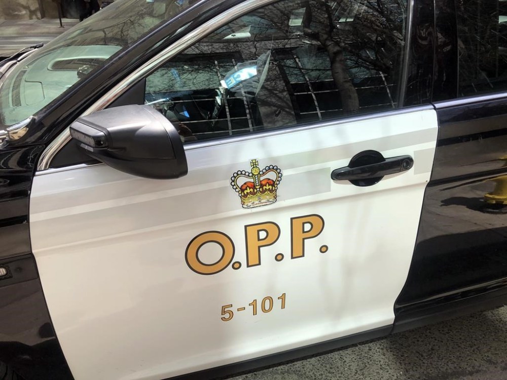 An Ontario Provincial Police vehicle sits idle in Toronto, Tuesday, April 11, 2023. Ontario Provincial Police are investigating a double homicide in Pembroke early Monday morning that left a third person with life-threatening injuries. THE CANADIAN PRESS/Tammy Hoy