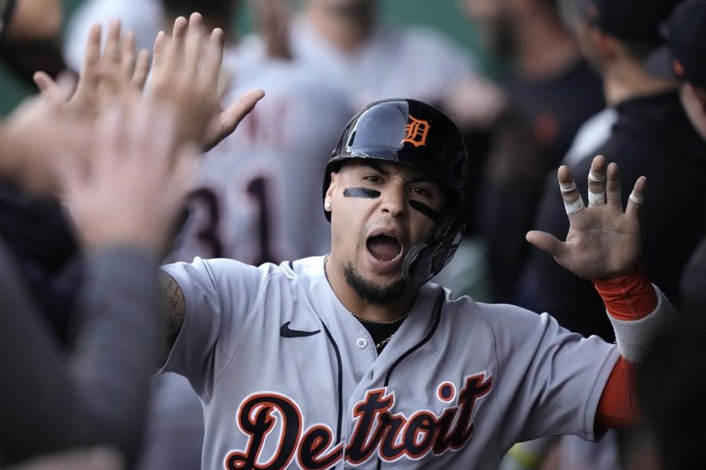 Detroit Tigers' Javier Baez celebrates in the dugout after scoring on a two-run single hit by Matt Vierling during the first inning of a baseball game Monday, May 22, 2023, in Kansas City, Mo. (AP Photo/Charlie Riedel)
