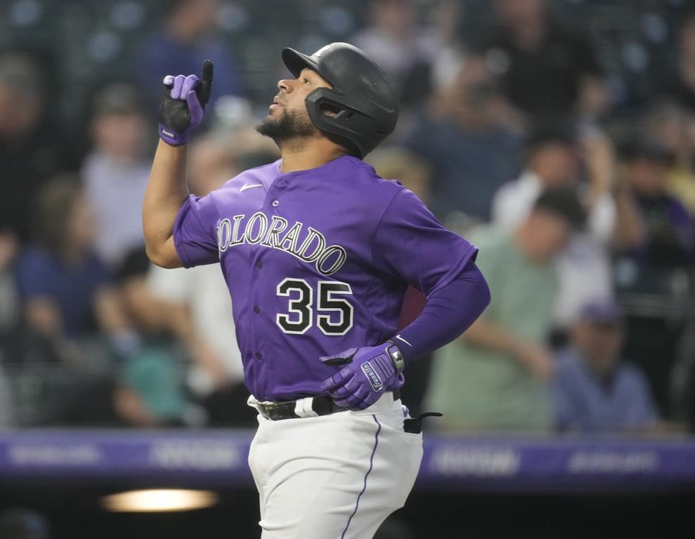 Colorado Rockies' Elias Diaz gestures as he crosses home plate after hitting a solo home run off Miami Marlins starting pitcher Edward Cabrera in the sixth inning of a baseball game Monday, May 22, 2023, in Denver. (AP Photo/David Zalubowski)