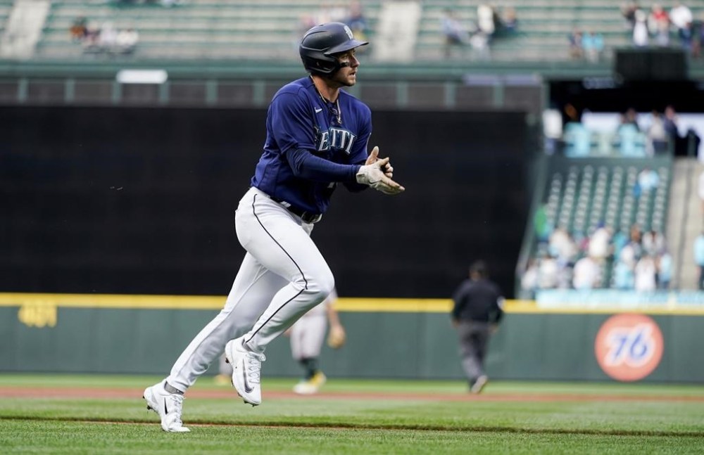 Seattle Mariners' Jarred Kelenic claps as he runs the bases after hitting a two-run home run against the Oakland Athletics during the first inning of a baseball game Monday, May 22, 2023, in Seattle. (AP Photo/Lindsey Wasson)